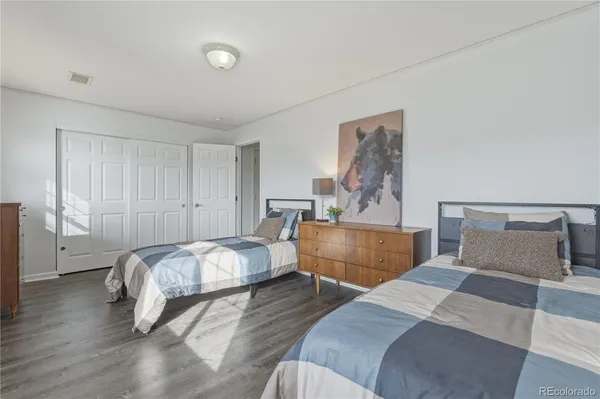 a bedroom with furniture and wooden floor