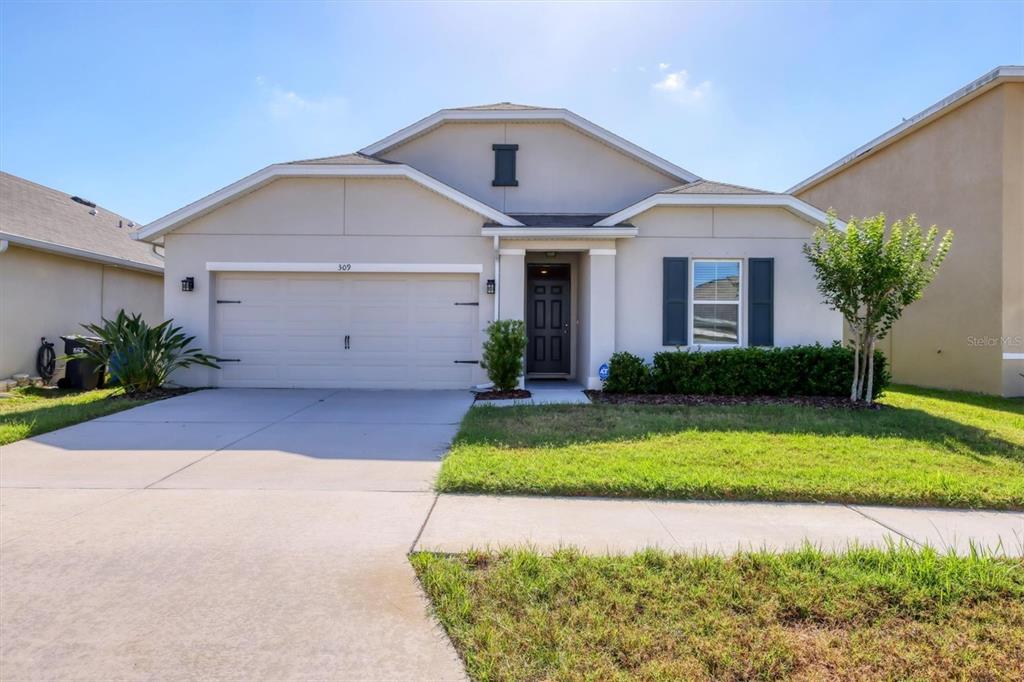 309 Blue Point Drive Ruskin, FL 33570 - Photo 1 of 1 a front view of a house with a yard and garage