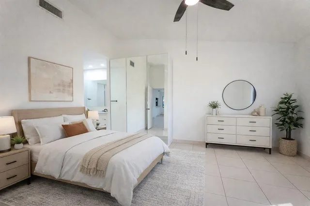 a bedroom with a bed and a dresser