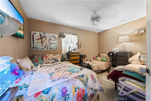 a bedroom with a bed table and a window