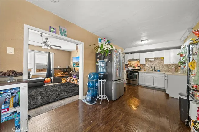 a living room with furniture fireplace and a large window