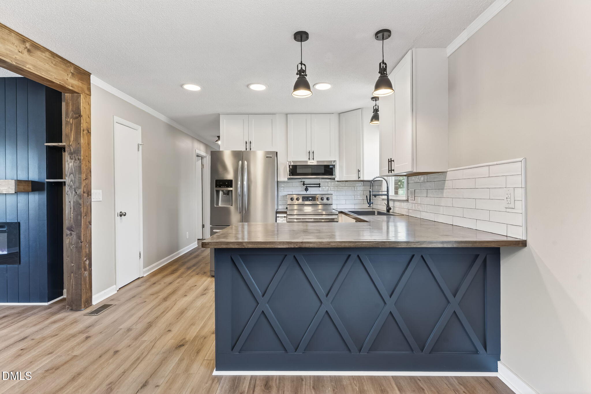 6086 Red Hill Church Road Coats, NC 27521 - Photo 12 of 44 a kitchen with kitchen island granite countertop a sink cabinets and stainless steel appliances