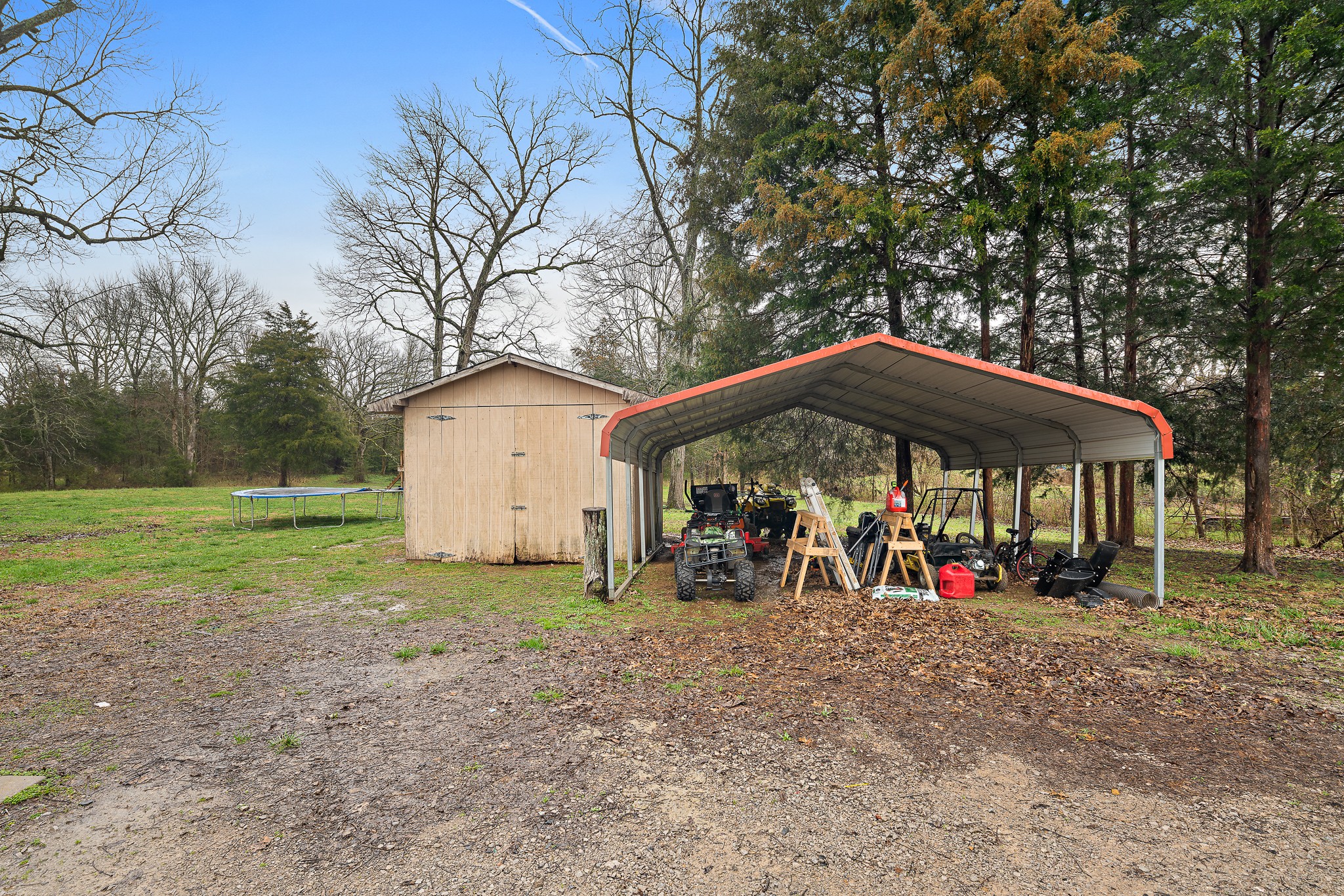 13577 Versailles Road Rockvale, TN 37153 - Photo 49 of 50 a view of patio with a table and chairs under an umbrella