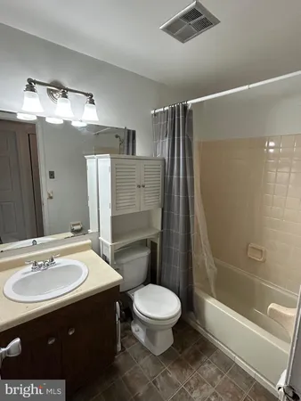 a bathroom with a sink toilet a mirror and shower