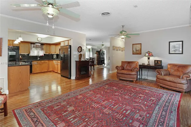 a living room with furniture and a dining table
