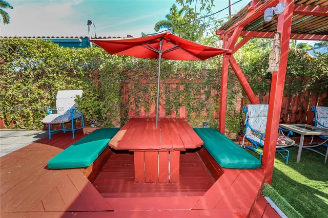 a view of a yard with furniture and a table