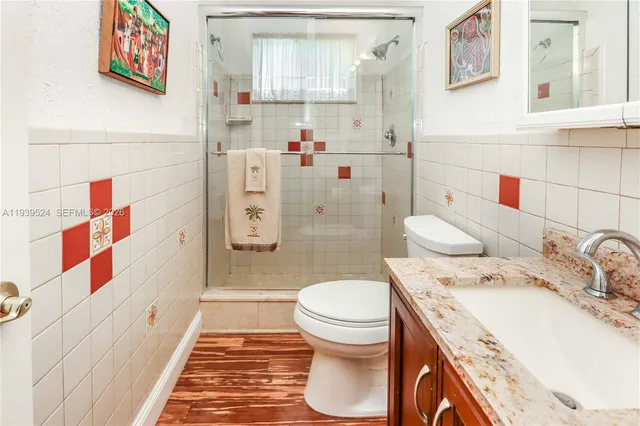 a bathroom with a sink toilet and shower