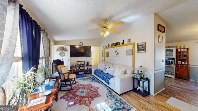 a living room with furniture and wooden floor