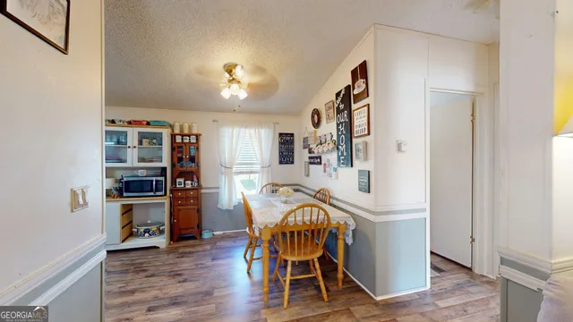 a view of a dining room with furniture and wooden floor