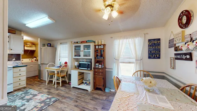 a living room with furniture a dining table and a window