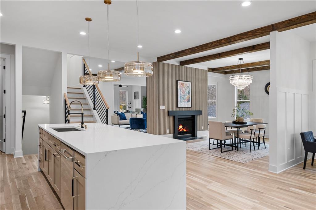 515 Chevelle Lane Decatur, GA 30030 - Photo 11 of 39 a open kitchen with stainless steel appliances kitchen island a dining table chairs and couches with wooden floor