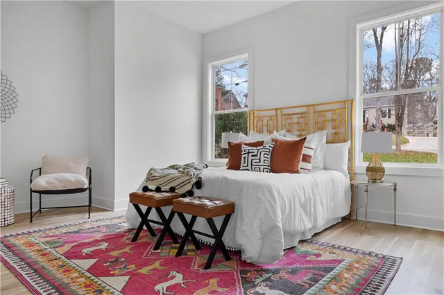 a bedroom with a bed and wooden floor