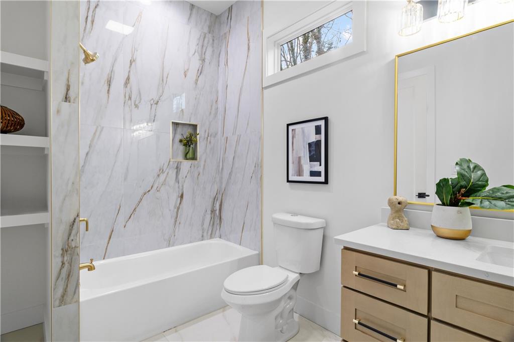515 Chevelle Lane Decatur, GA 30030 - Photo 20 of 39 a bathroom with a sink a toilet and shower