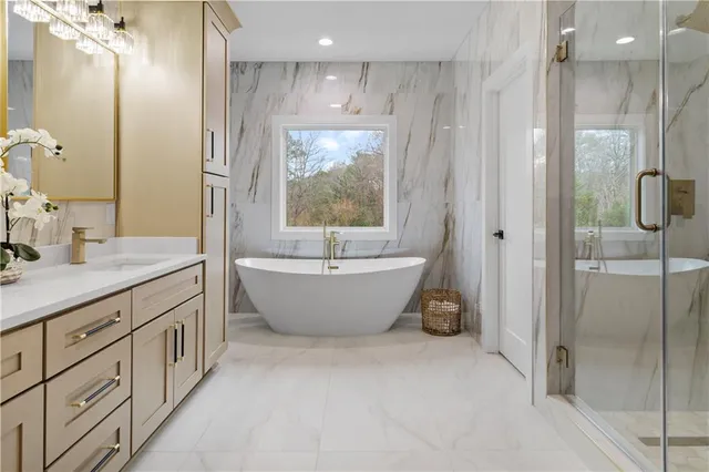 a bathroom with a bathtub and a shower