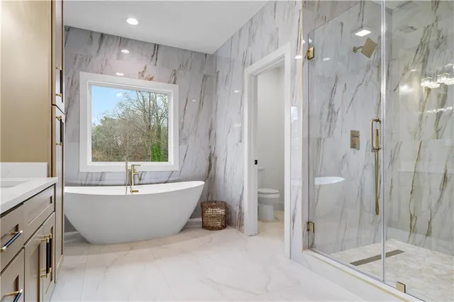a spacious bathroom with a bathtub and shower