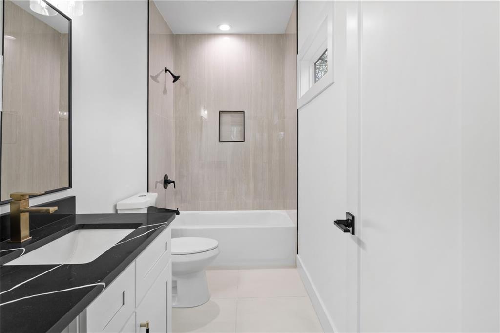 515 Chevelle Lane Decatur, GA 30030 - Photo 35 of 39 a bathroom with a granite countertop sink toilet and shower