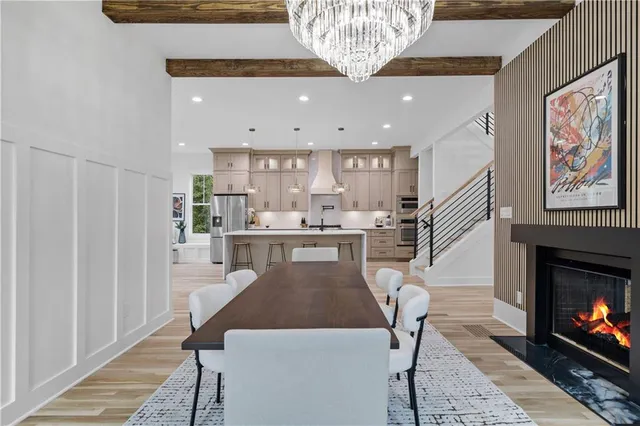 a open kitchen with a table chairs and a fireplace