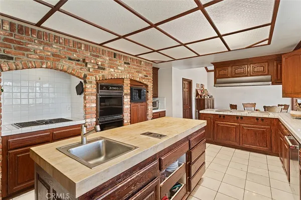 a kitchen with a sink appliances and cabinets