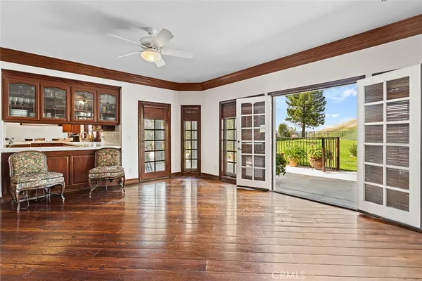 a living room with furniture and large windows