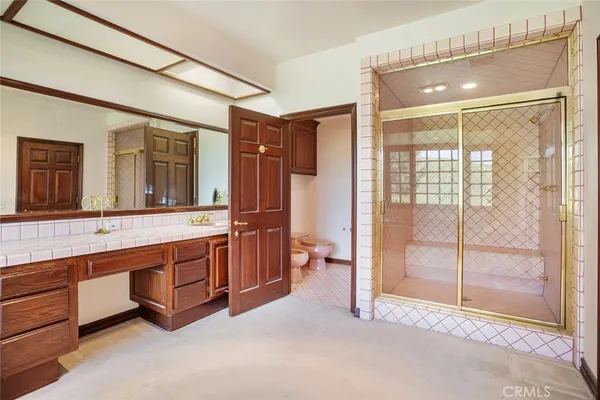 a spacious bathroom with a glass shower door and a sink