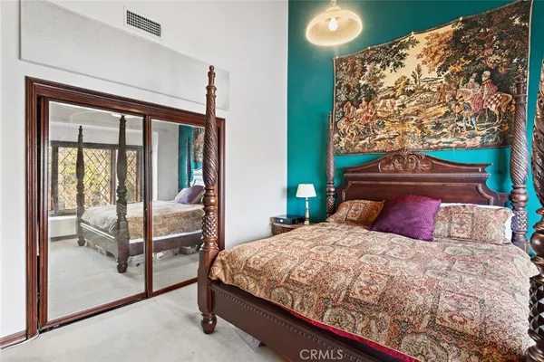 a bedroom with a bed and a large window
