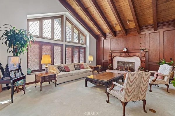 a bedroom with furniture and a large window