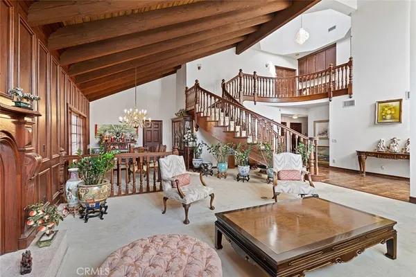 a living room with patio furniture and a potted plant