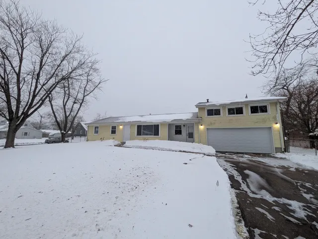 a view of a house with a snow in the yard