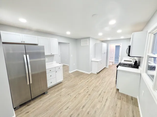 a kitchen with stainless steel appliances a refrigerator and a stove top oven