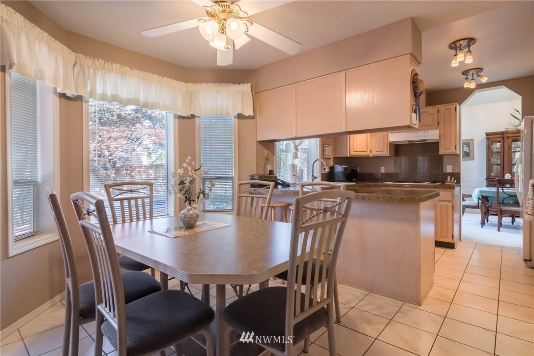 36907 17th Avenue South Federal Way, WA 98003 - Photo 11 of 25 a dining room with furniture a chandelier and kitchen view