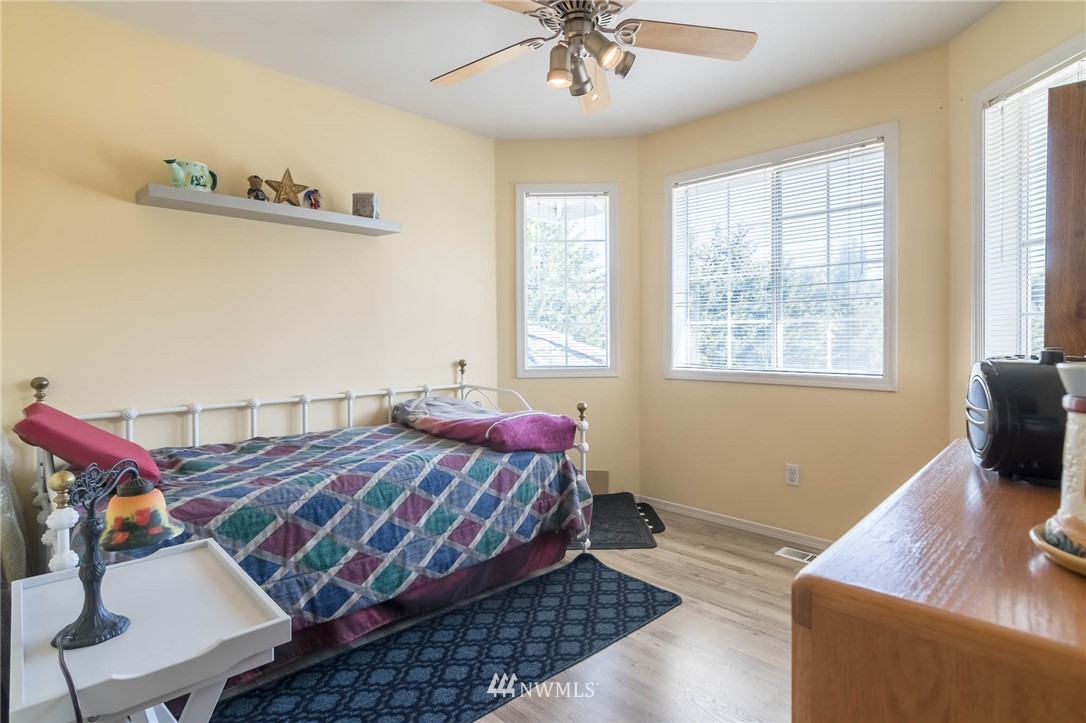 36907 17th Avenue South Federal Way, WA 98003 - Photo 20 of 25 a bedroom with a bed and wooden floor
