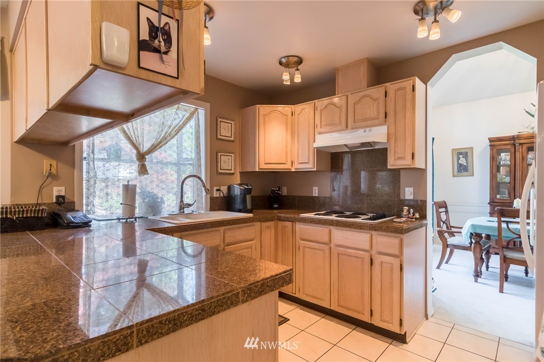 36907 17th Avenue South Federal Way, WA 98003 - Photo 9 of 25 a kitchen with stainless steel appliances granite countertop a sink stove and cabinets