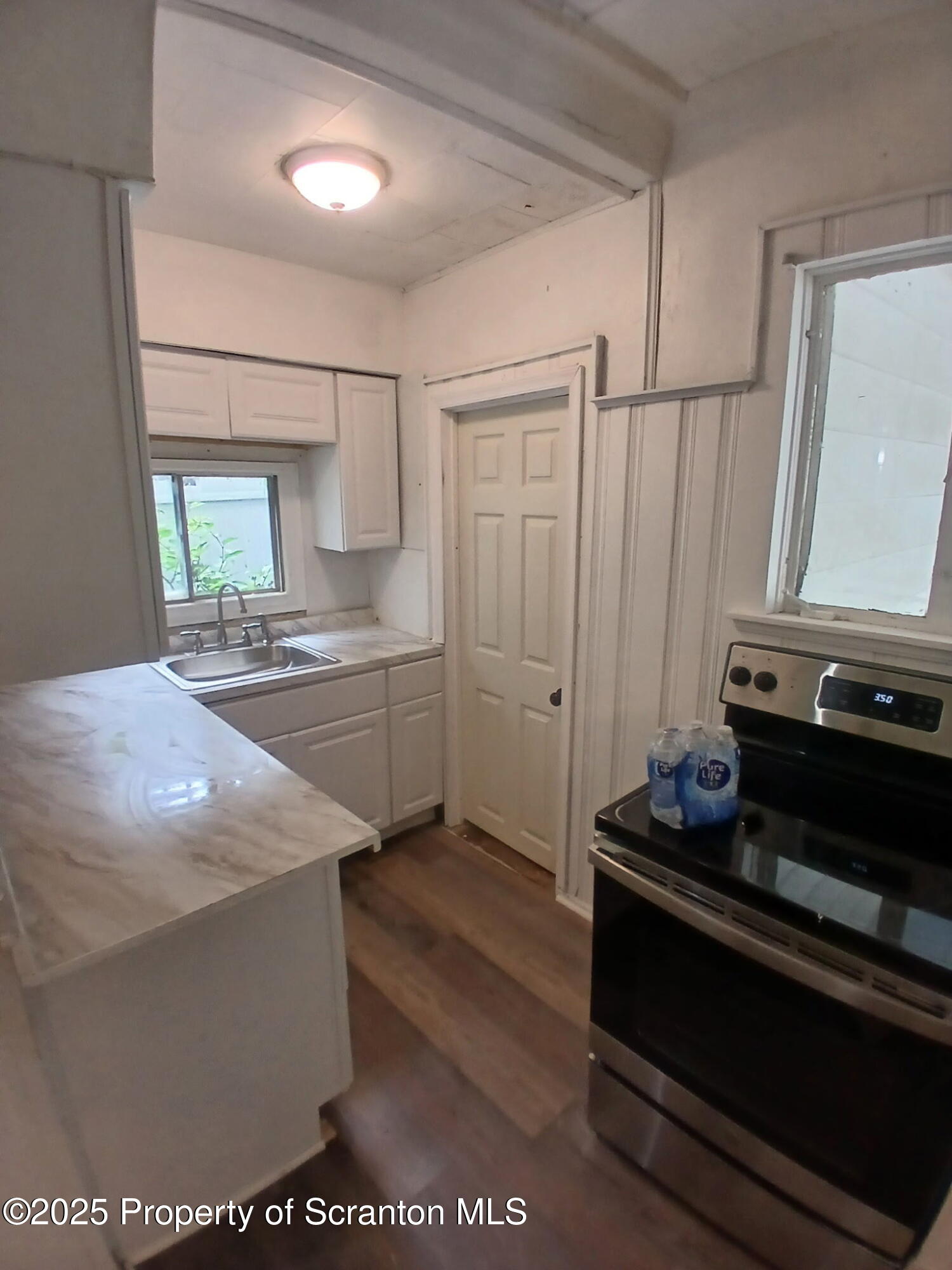 1729 Church Avenue, Unit 1 Scranton, PA 18508 - Photo 2 of 8 a kitchen with kitchen island sink stove and cabinets