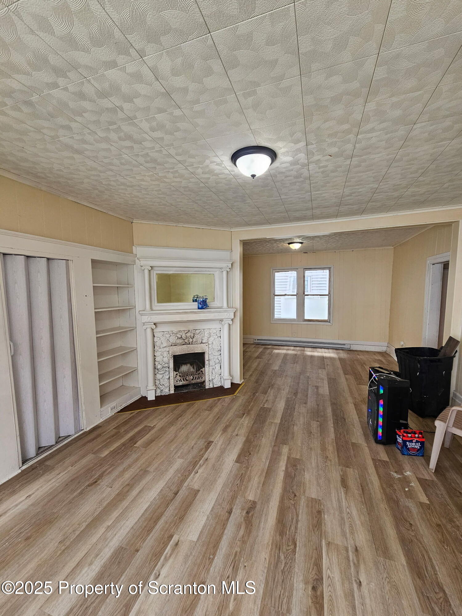 1729 Church Avenue, Unit 1 Scranton, PA 18508 - Photo 4 of 8 a view of empty room with fireplace and windows