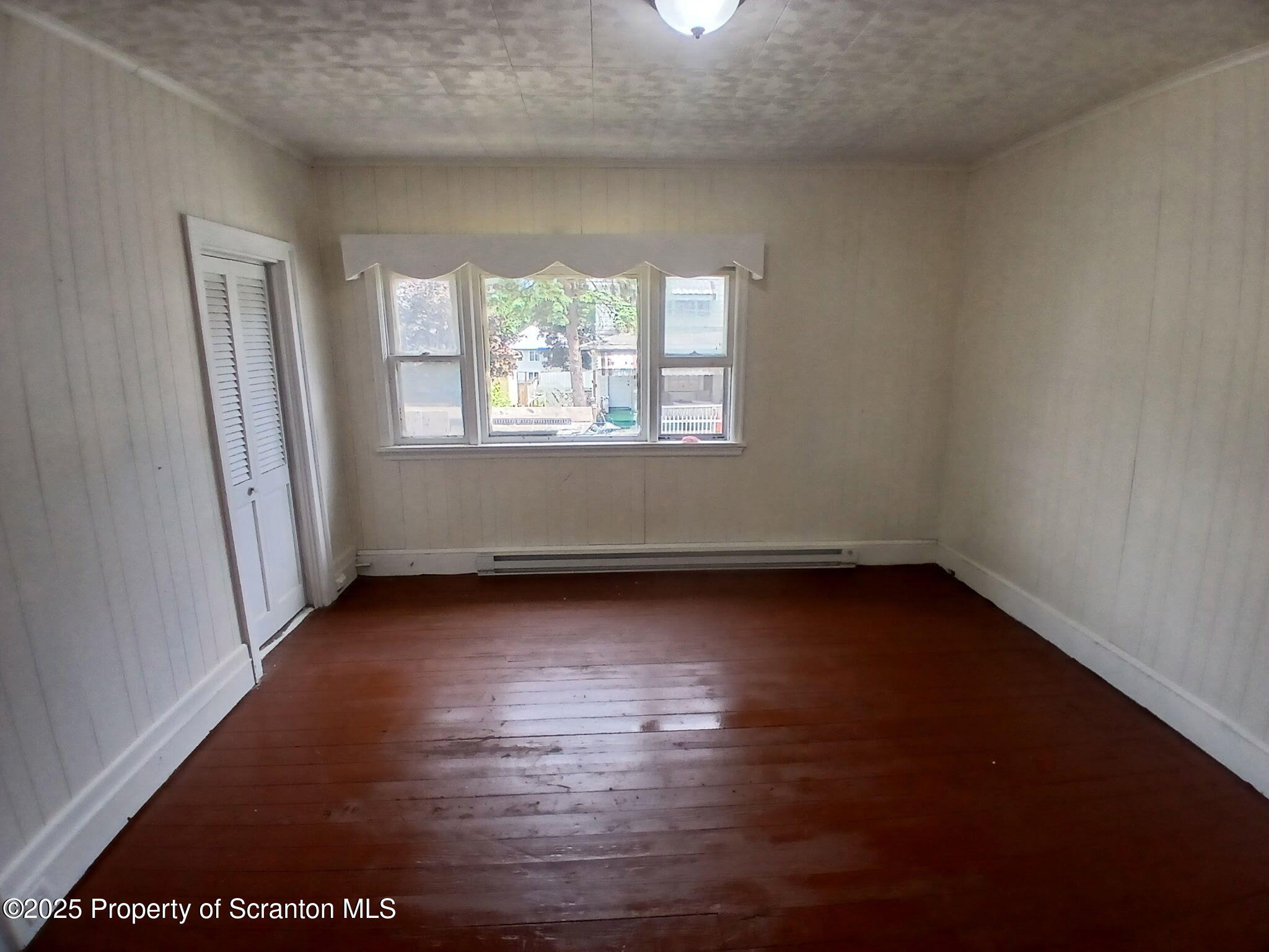 1729 Church Avenue, Unit 1 Scranton, PA 18508 - Photo 6 of 8 an empty room with wooden floor and windows