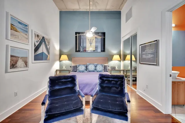 a bedroom with a bed and wooden floor