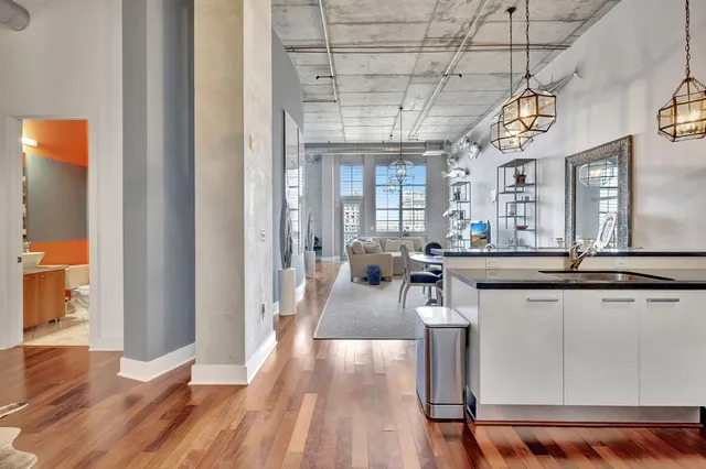 a view of a kitchen with a sink and refrigerator