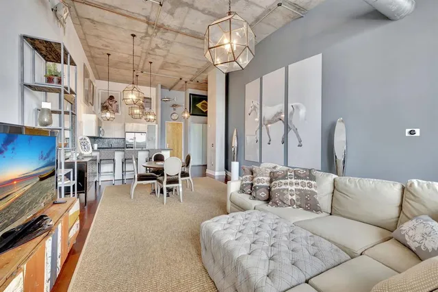 a living room with fireplace furniture and a chandelier