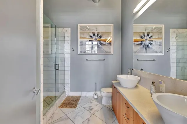 a front view of a building with a garden and plants