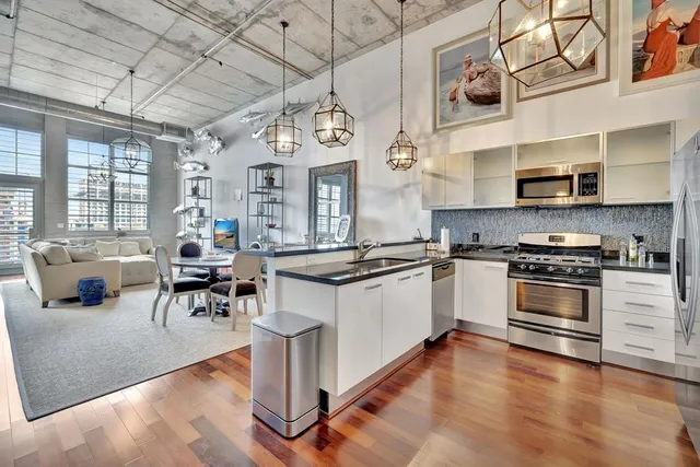 a kitchen with sink refrigerator and large window