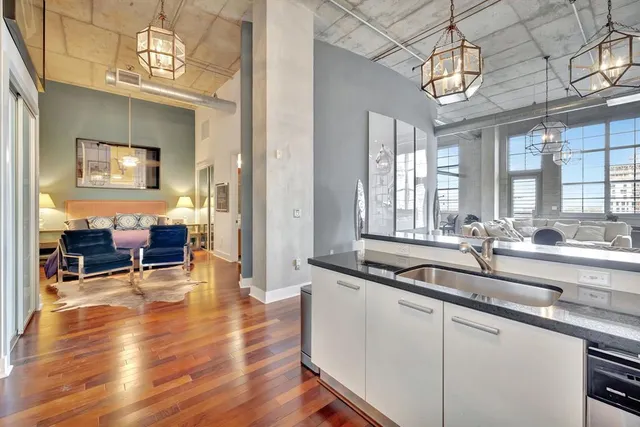 a kitchen with stainless steel appliances granite countertop a sink and a refrigerator