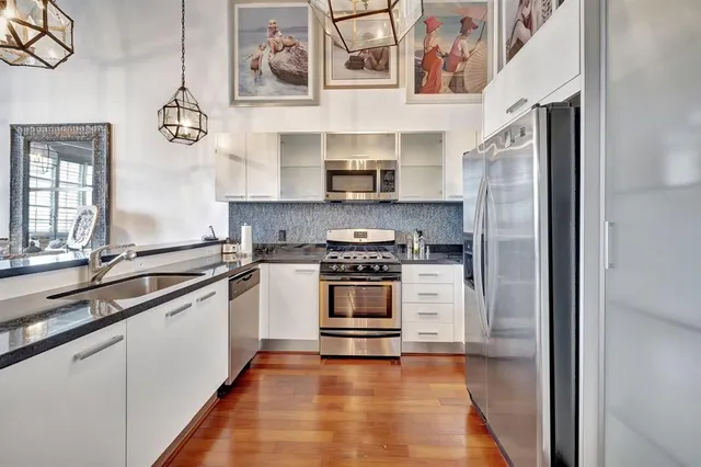 a kitchen with stainless steel appliances granite countertop a stove and a sink