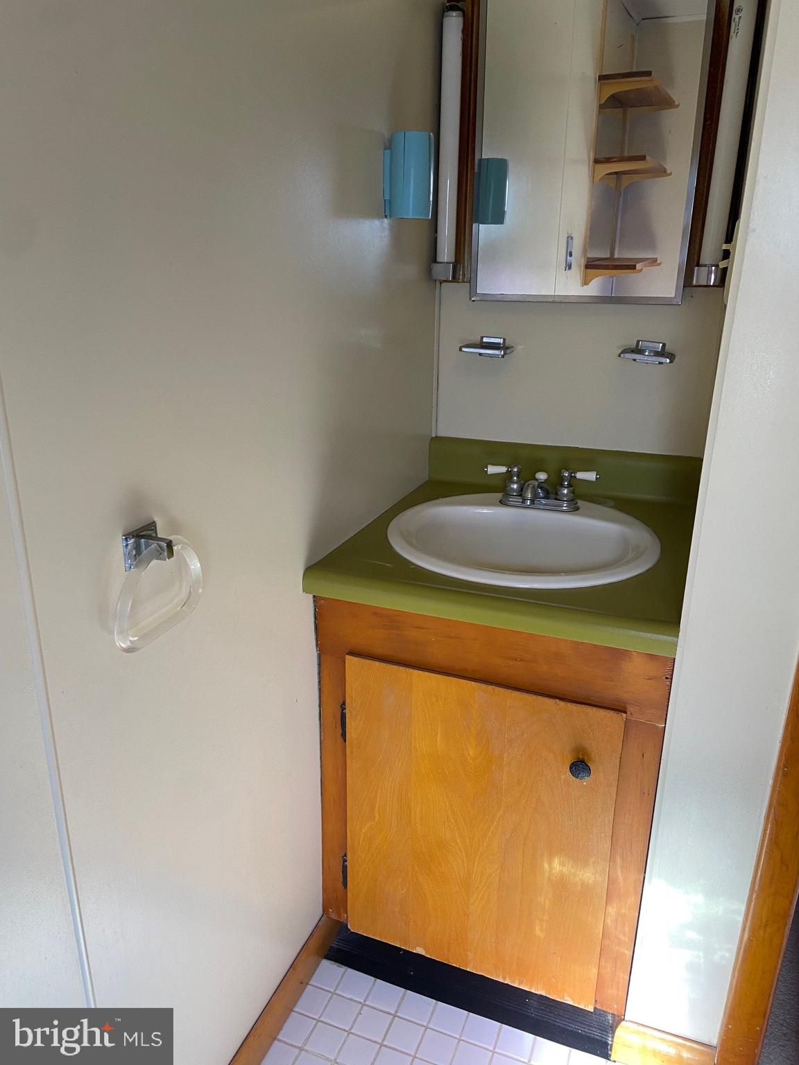 74 South Broadway Pennsville, NJ 08070 - Photo 15 of 22 a bathroom with a sink and a mirror