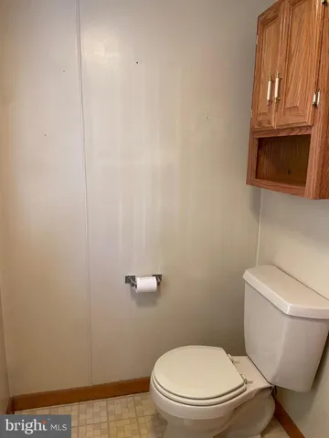 a white toilet sitting next to a shower