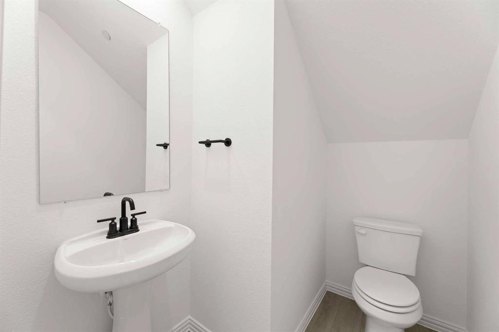 631 Blue Rdg Drive Mansfield, TX 76063 - Photo 12 of 30 a bathroom with a sink a toilet and a mirror