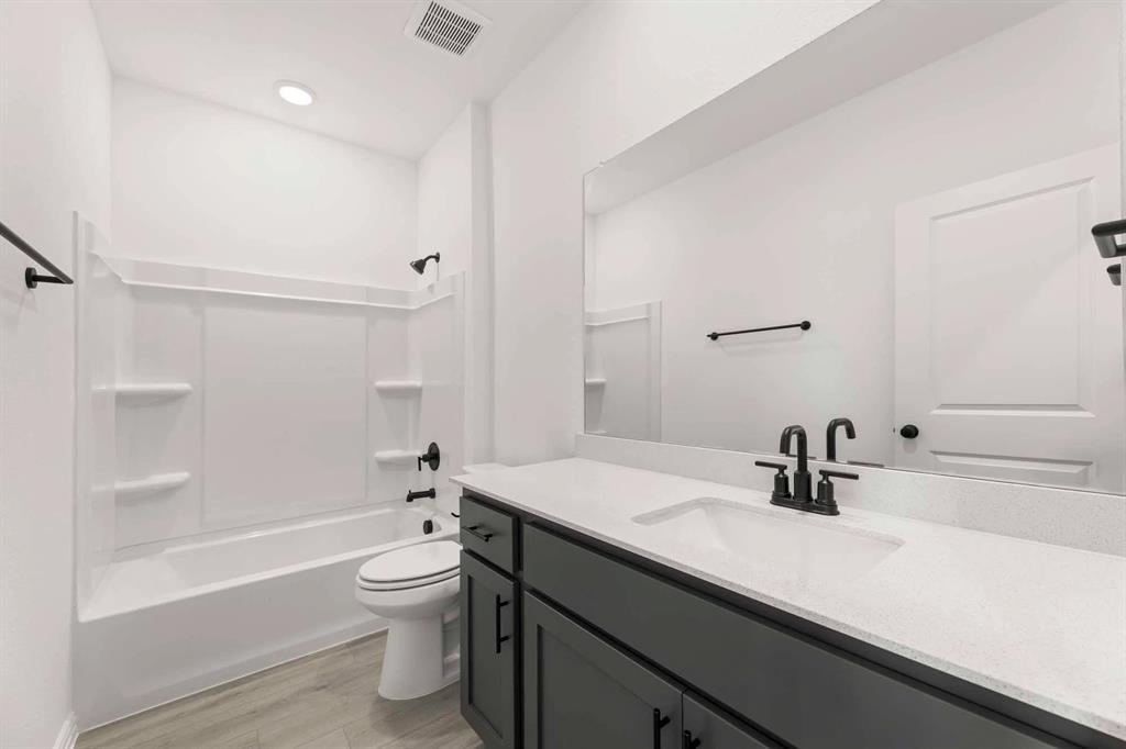 631 Blue Rdg Drive Mansfield, TX 76063 - Photo 18 of 30 a bathroom with a sink a toilet and a large mirror