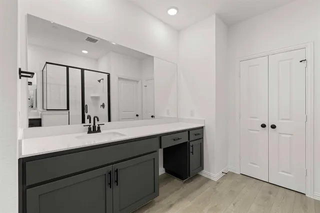 a bathroom with a double vanity sink and mirror