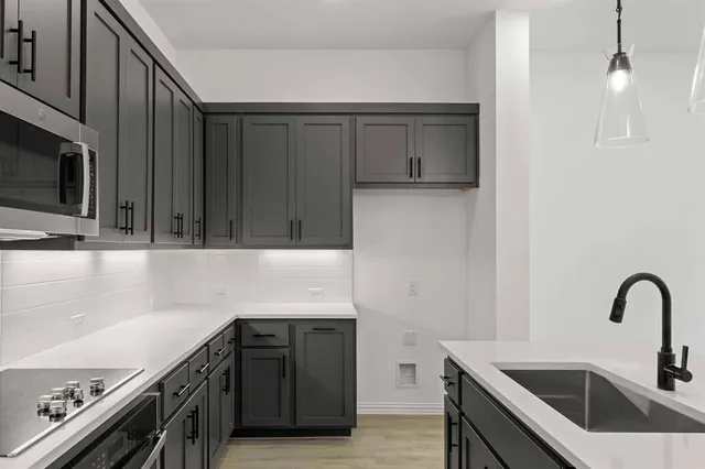 a kitchen with a sink and cabinets