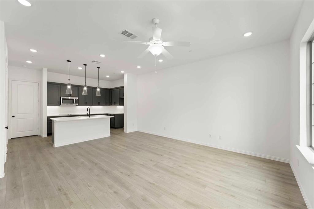 631 Blue Rdg Drive Mansfield, TX 76063 - Photo 5 of 30 a view of kitchen with kitchen island a sink stainless steel appliances and cabinets