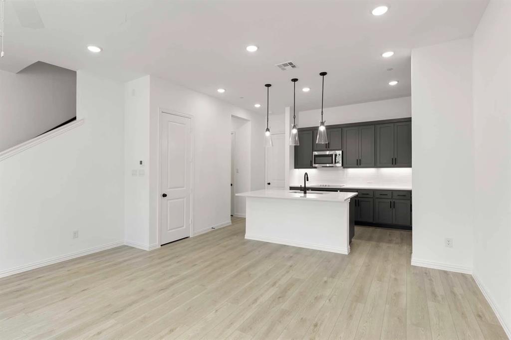 631 Blue Rdg Drive Mansfield, TX 76063 - Photo 6 of 30 a large white kitchen with a refrigerator a sink dishwasher a stove and a oven with wooden floor